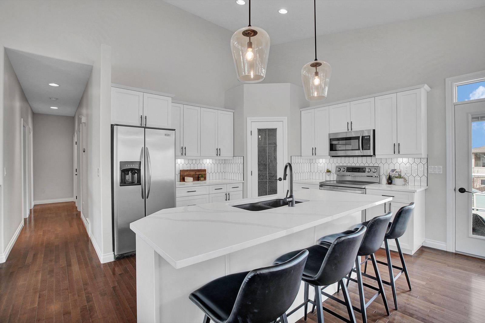 White kitchen with quartz island staged by Aimee Lauren Interiors