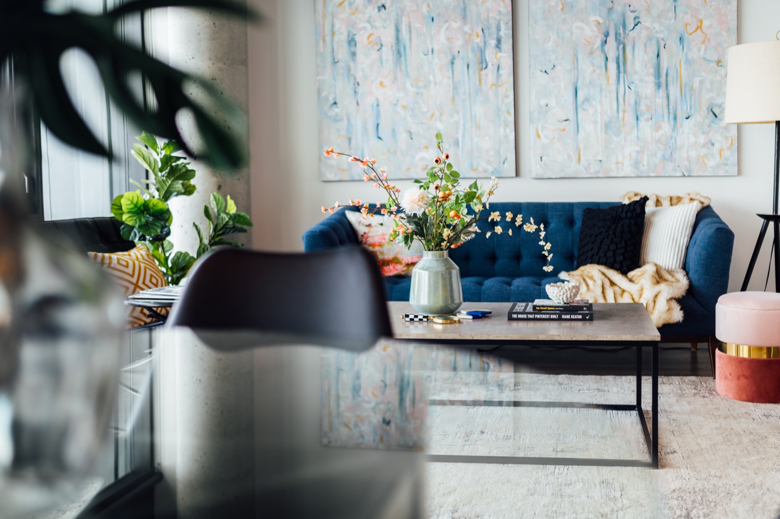 Living room styled by Aimee Lauren Interiors with a blue velvet sofa and abstract artwork