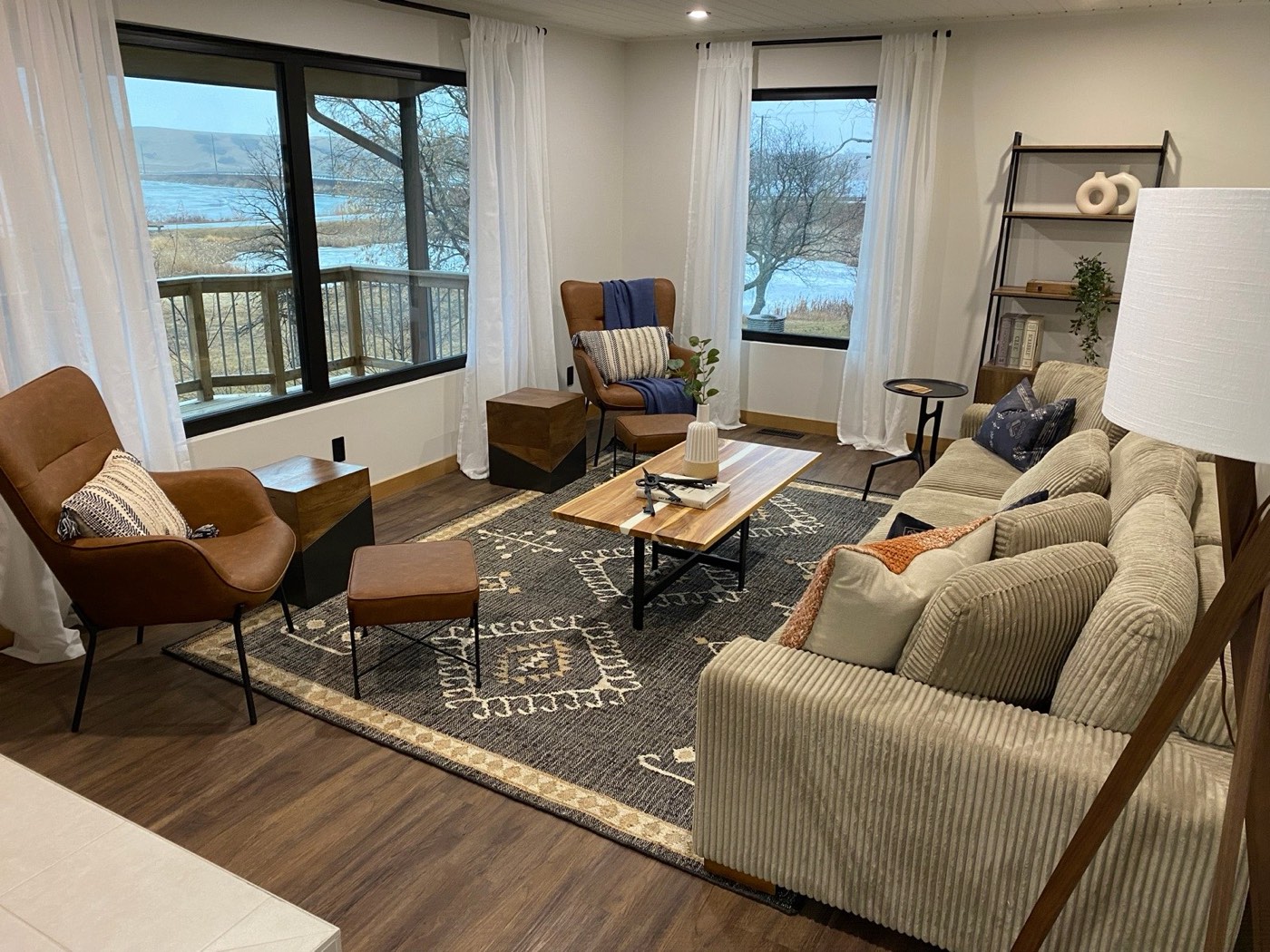 Staged living room with lake views and layered textiles by Aimee Lauren Interiors